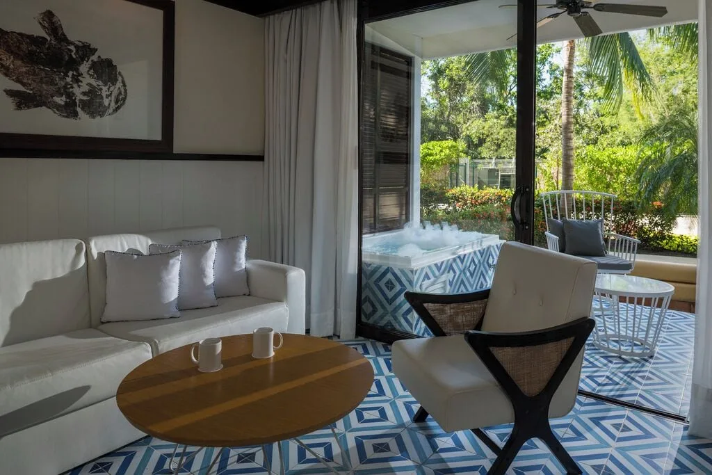 Junior Suite Eden sitting area opening to a Jacuzzi terrace at Ocean Riviera Paradise.
