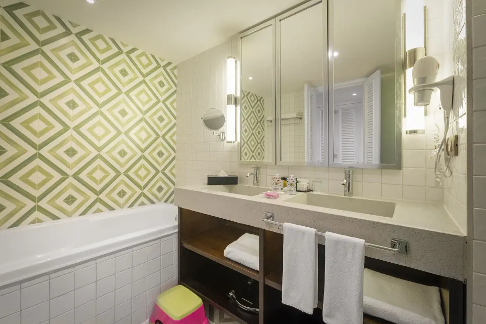 Junior Suite Waterpark Side bathroom with tub and double vanity at Ocean Riviera Paradise.