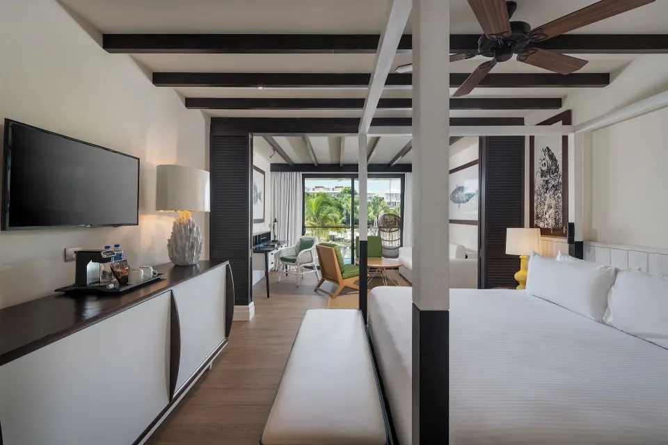 Junior Suite Waterpark Side with king bed and balcony at Ocean Riviera Paradise.