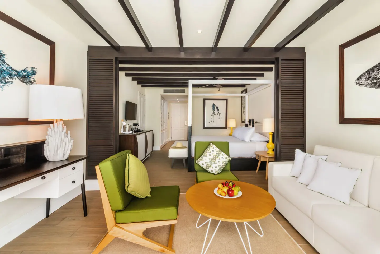 Junior Suite Waterpark Side living area and king bed at Ocean Riviera Paradise.