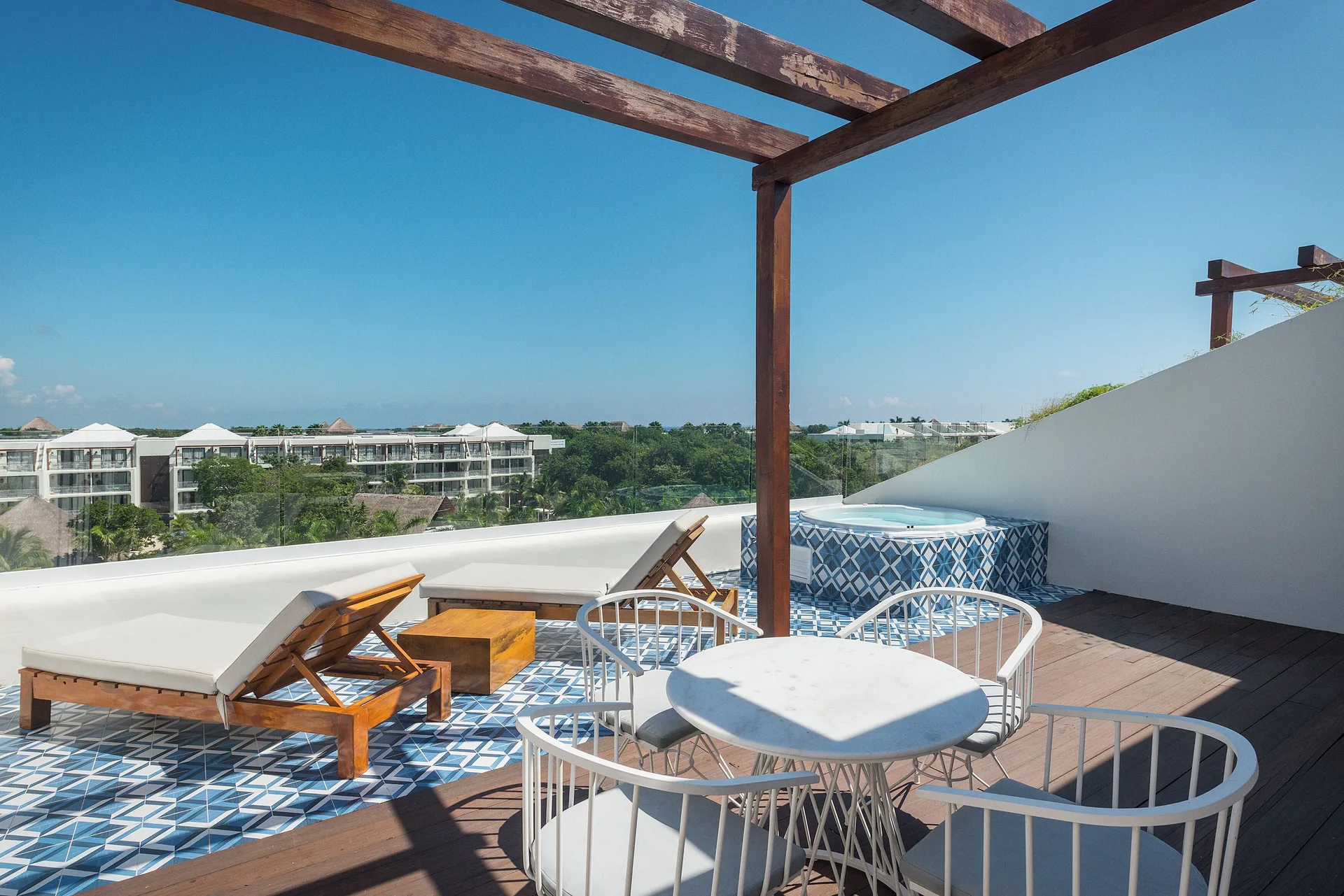 Paradise Junior Suite Swim Up terrace with loungers and hot tub at Ocean Riviera Paradise.