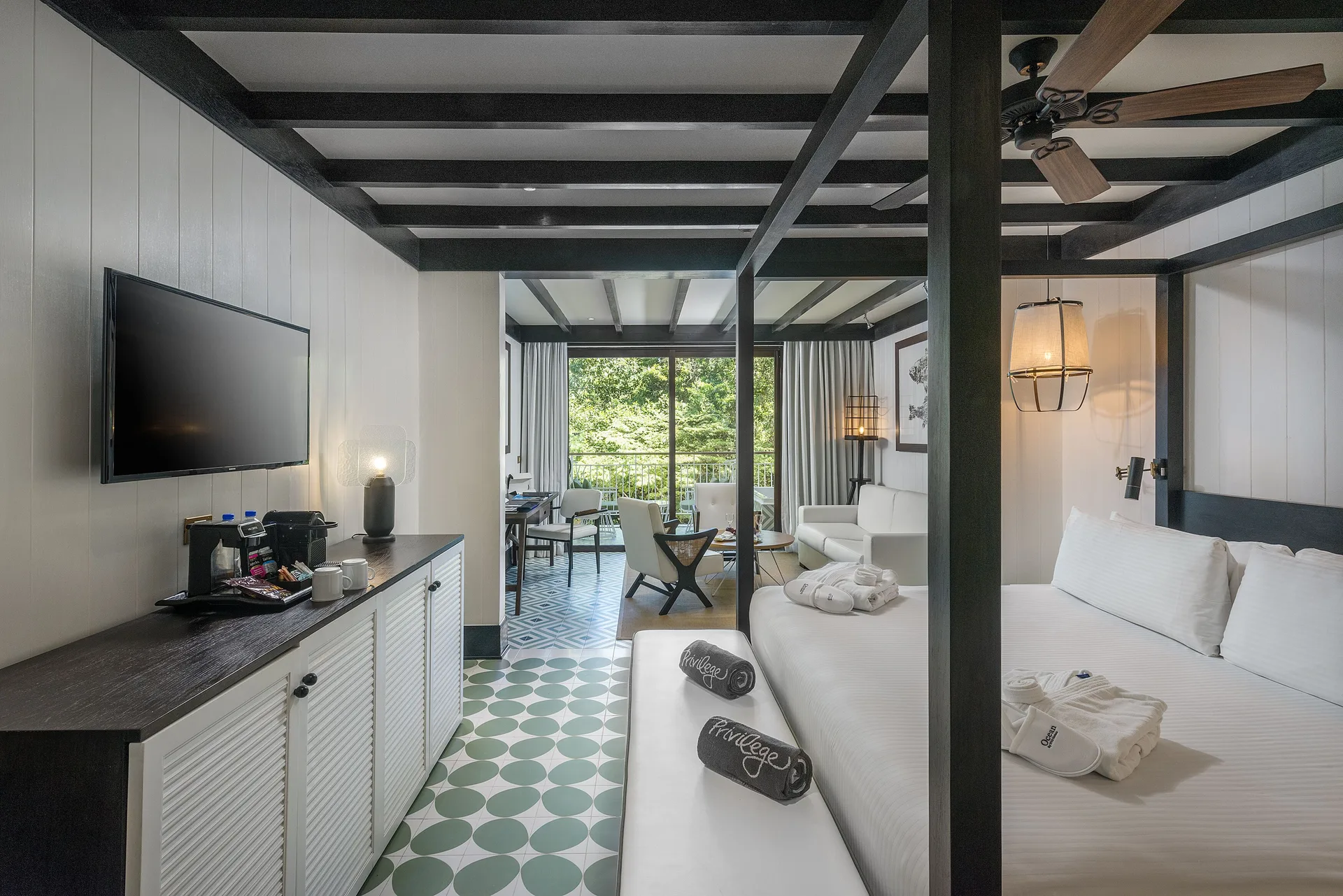 Privilege Junior Suite king bed, sofa, balcony, and nature view at Ocean Riviera Paradise.