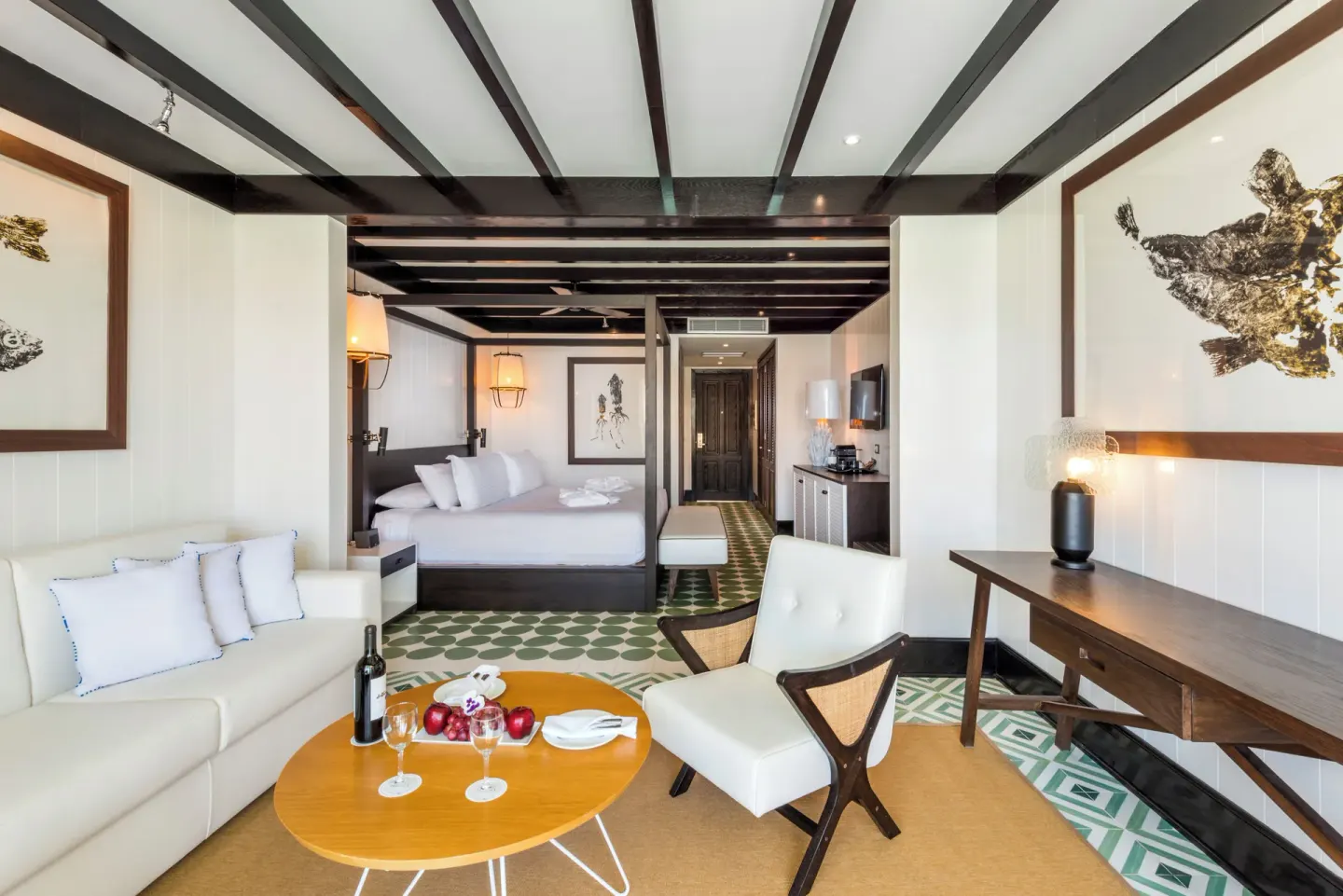 Privilege Junior Suite king bed and lounge with sofa and table at Ocean Riviera Paradise.