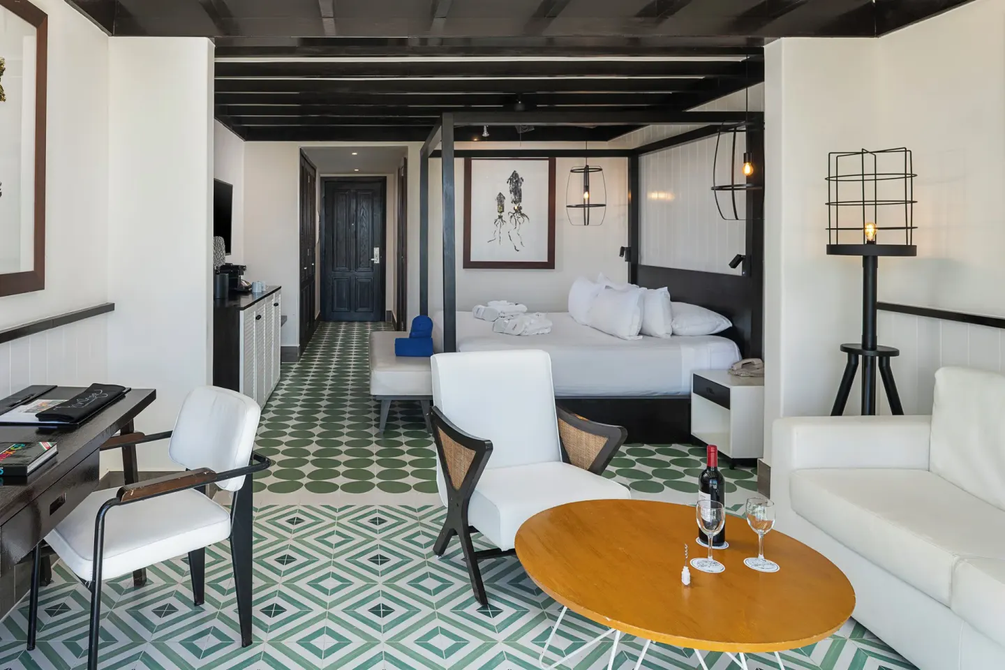 Privilege Junior Suite seating area, king bed, desk, and sofa at Ocean Riviera Paradise.