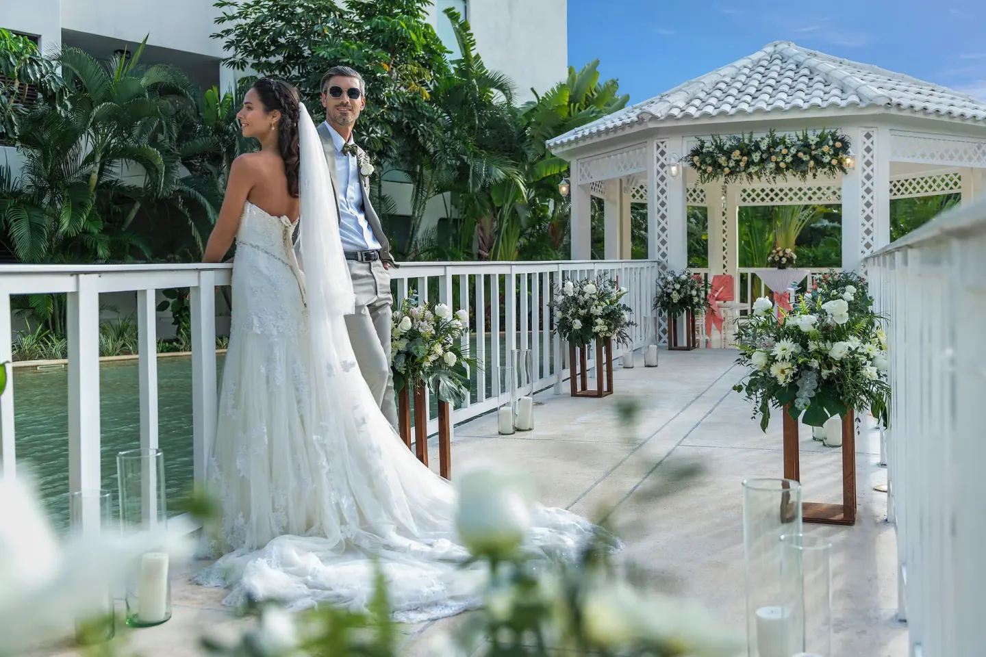 Bride and groom on a decorated garden bridge at Ocean Riviera Paradise.
