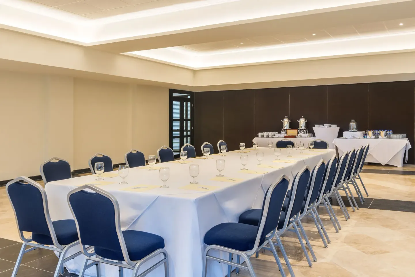Conference room with long table and beverage service at Ocean Riviera Paradise.