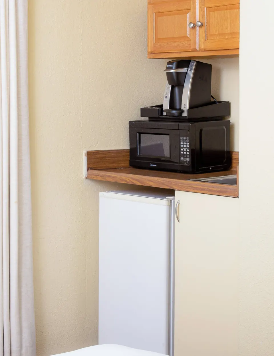 In-room kitchenette with microwave, coffee maker and mini fridge at Ohia Waikiki Studio Suites.