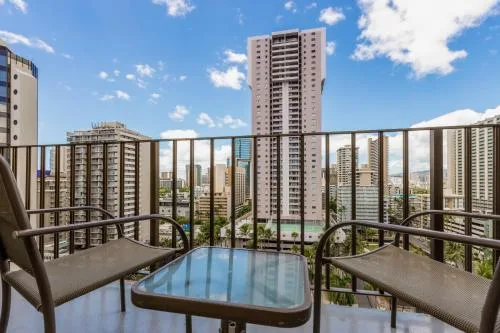 Sky View One Bed lanai seating faces Waikiki towers at Ohia Waikiki Studio Suites.
