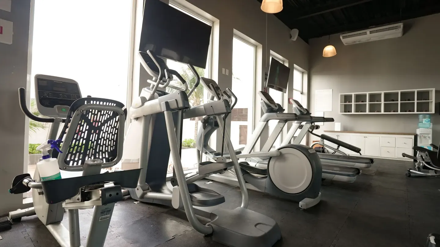 Cardio equipment and treadmills inside the gym at Oleo Cancun Playa Resort.