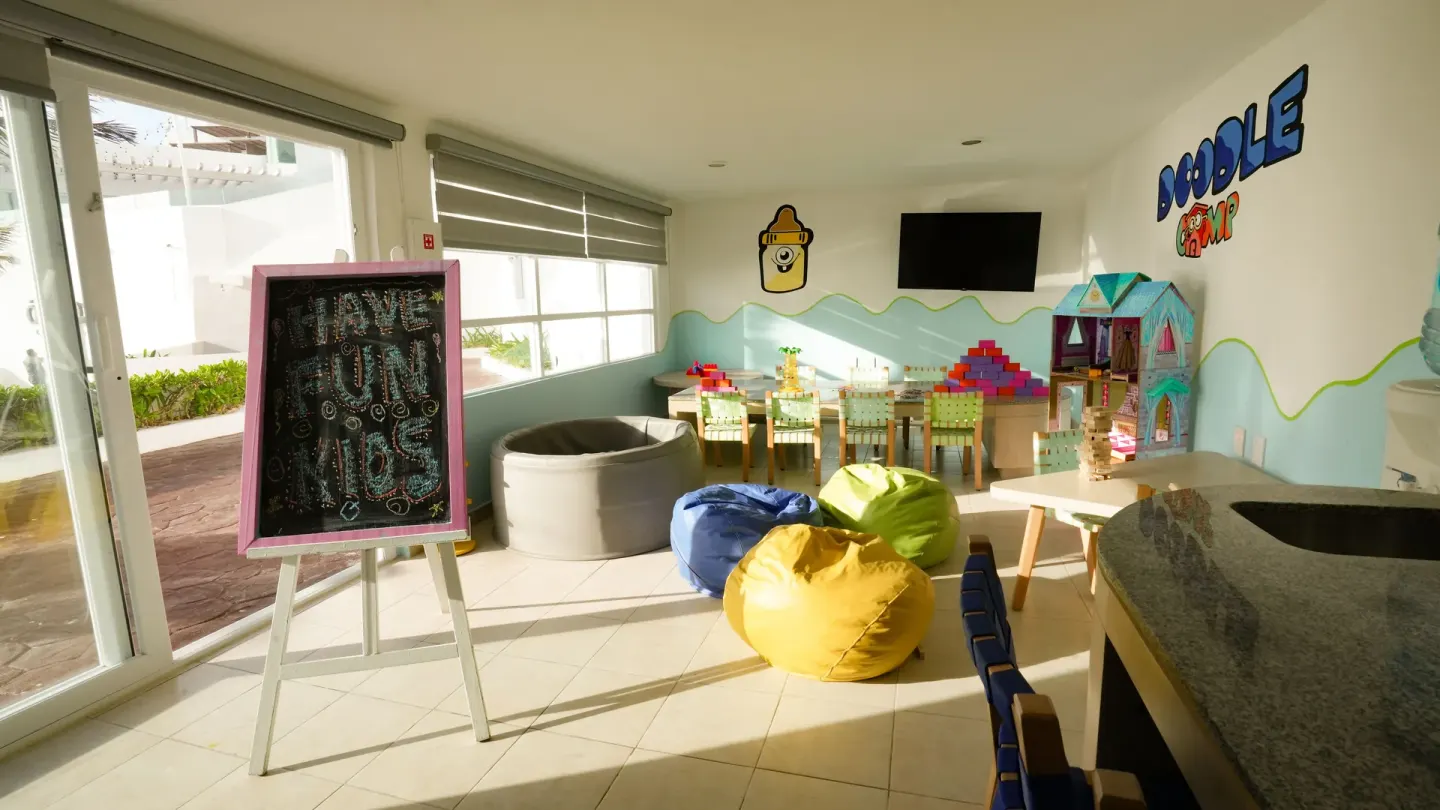 Kids club playroom with beanbags and toys at Oleo Cancun Playa Resort.
