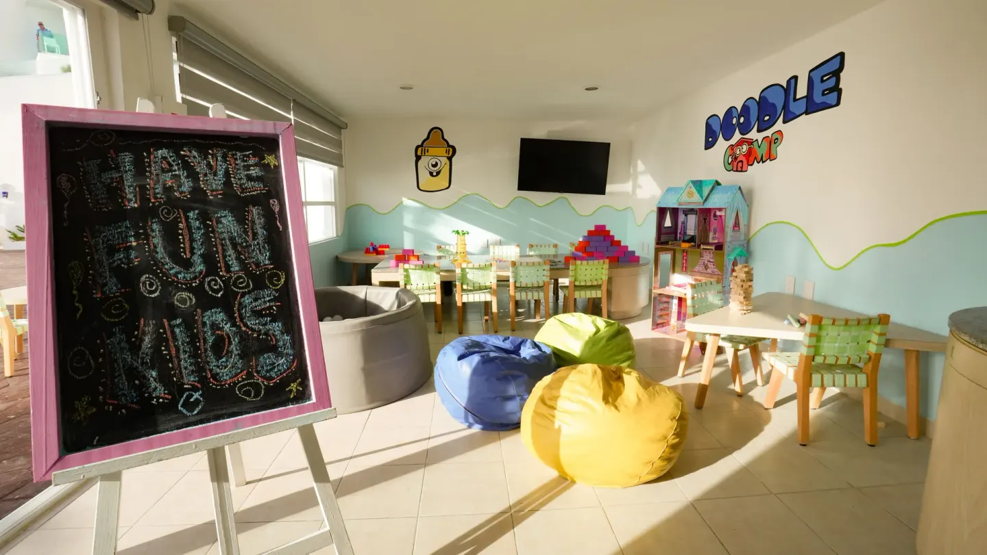 Colorful kids club playroom with beanbags and toys at Oleo Cancun Playa Resort.