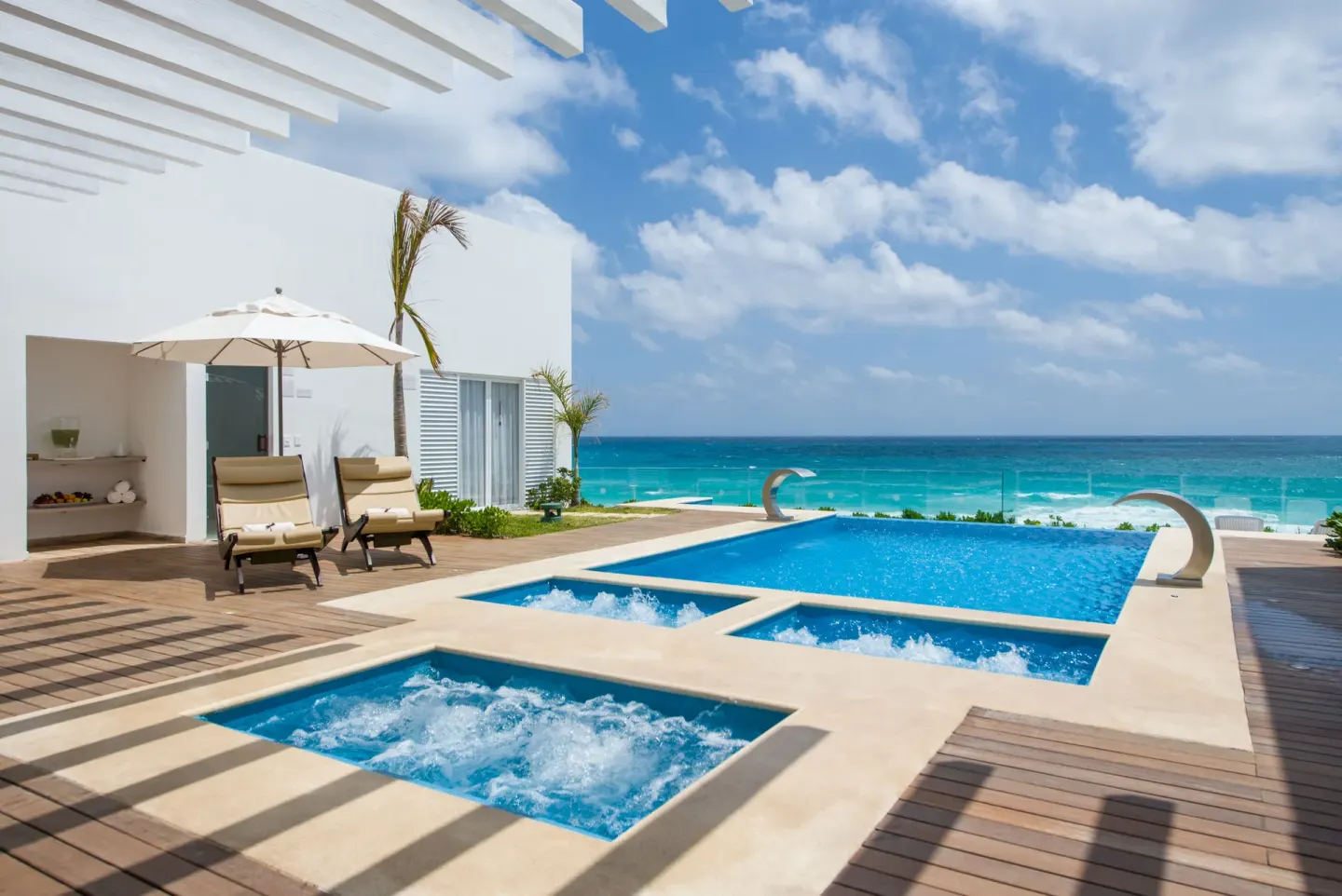 Private terrace pools with loungers and ocean views at Oleo Cancun Playa Resort.