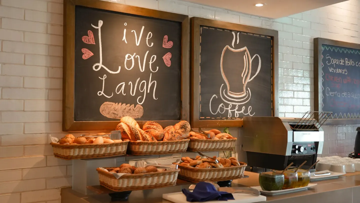 Bakery and coffee buffet with chalkboard art at Oleo Cancun Playa Resort.