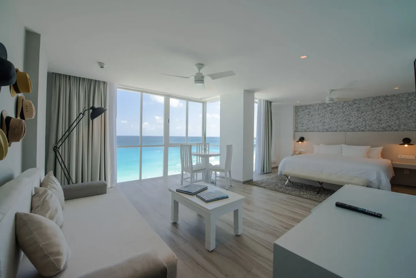 Inspira Junior Suite open bedroom and lounge facing the ocean at Oleo Cancun Playa Resort.