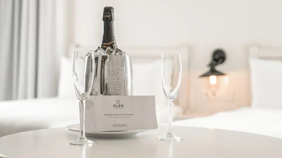 Welcome bottle with flutes in an Inspira Junior Suite at Oleo Cancun Playa Resort.