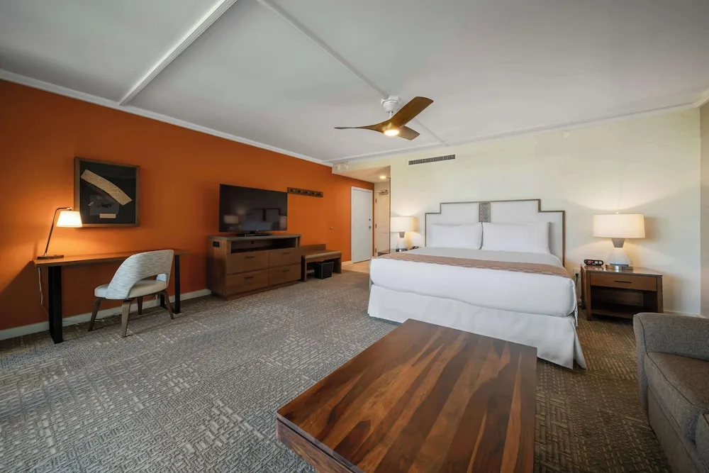 Large king guest room with desk and coffee table at Outrigger Kaanapali Beach Resort.