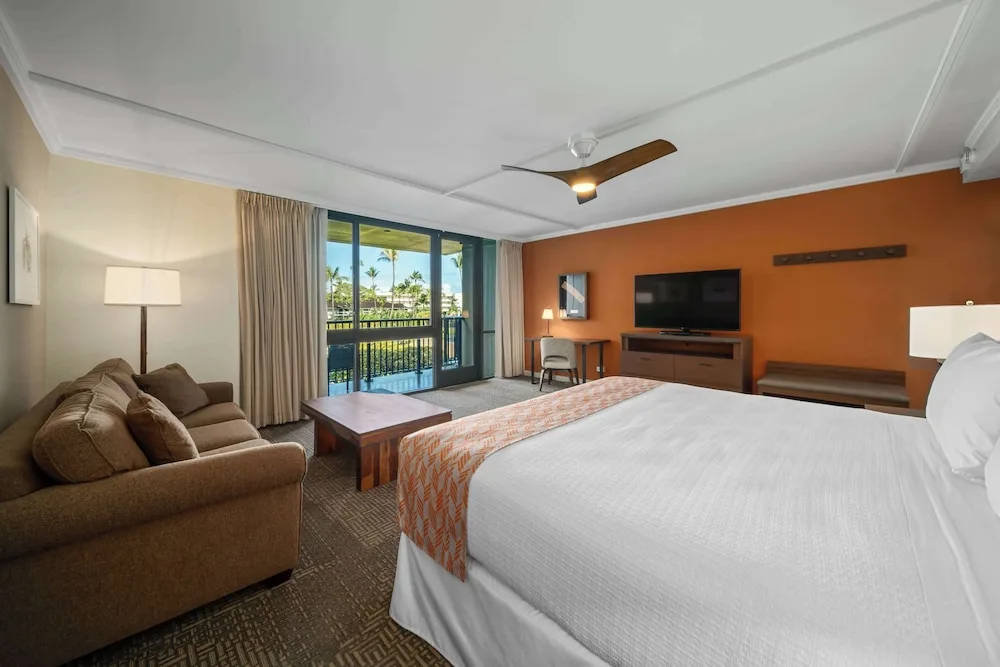 King guest room with sofa and balcony at Outrigger Kaanapali Beach Resort.