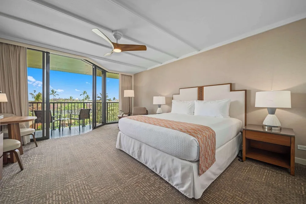 King guest room with wide balcony doors at Outrigger Kaanapali Beach Resort.