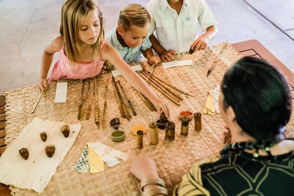 Children examine cultural craft materials at Outrigger Kaanapali Beach Resort.