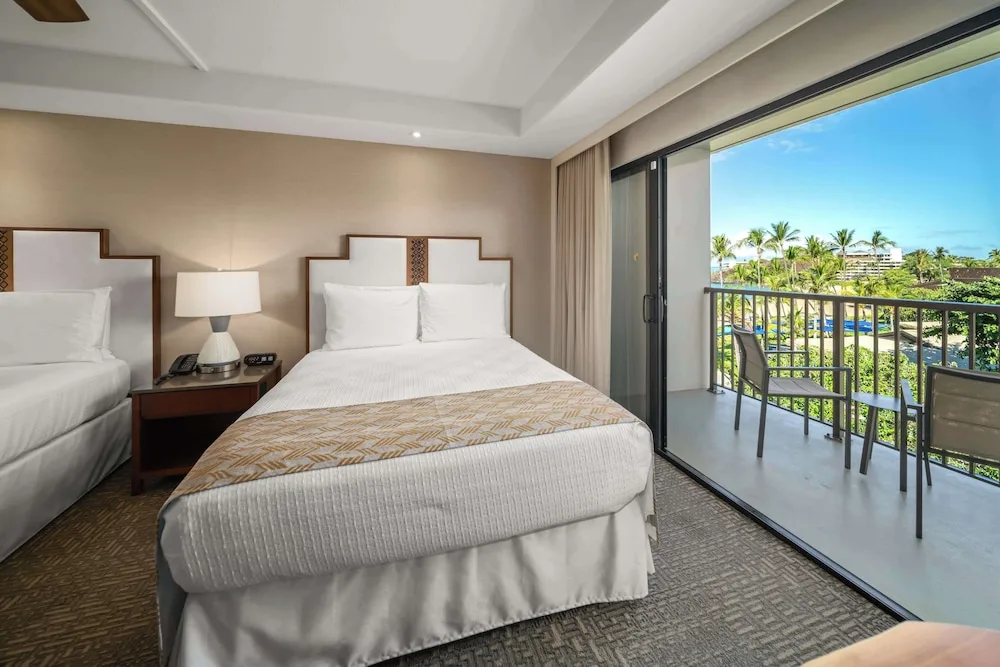 Guest room with two beds and an ocean-view lanai at Outrigger Kaanapali Beach Resort.