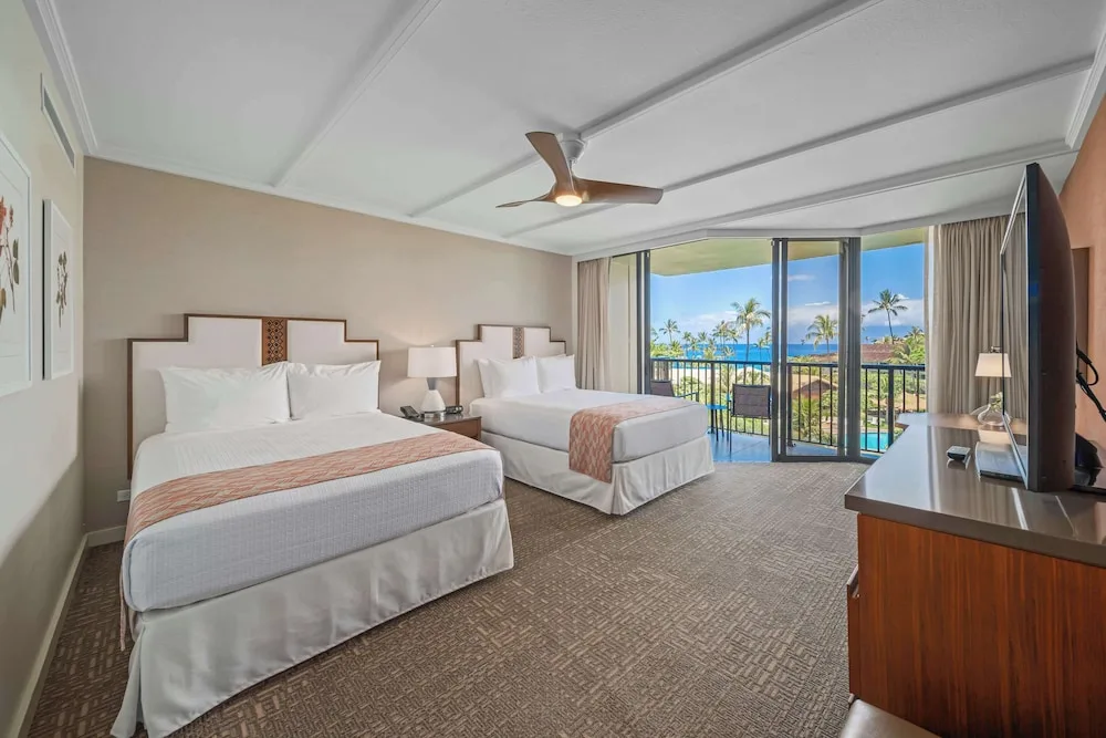 Two-bed guest room with balcony ocean view at Outrigger Kaanapali Beach Resort.