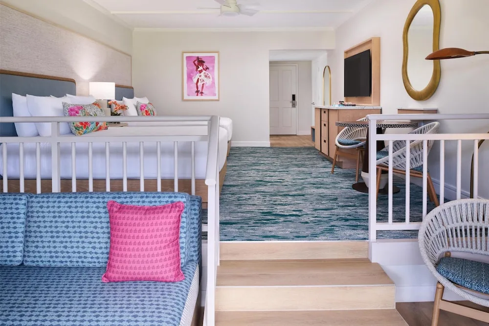 Split-level guest room with daybed, two beds and desk at Outrigger Kaanapali Beach Resort.