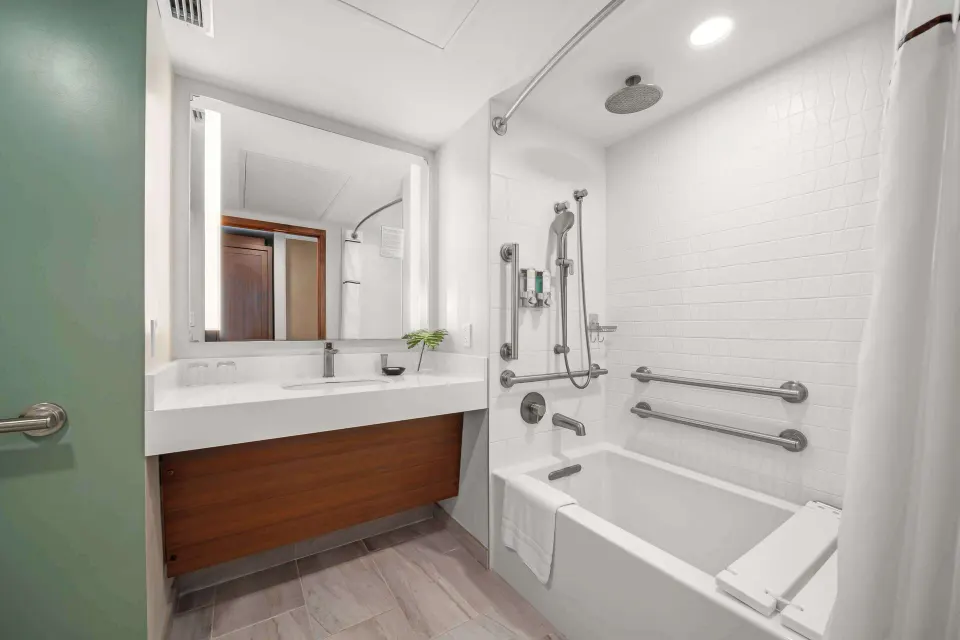 Accessible guest bathroom with tub and grab bars at Outrigger Kaanapali Beach Resort.