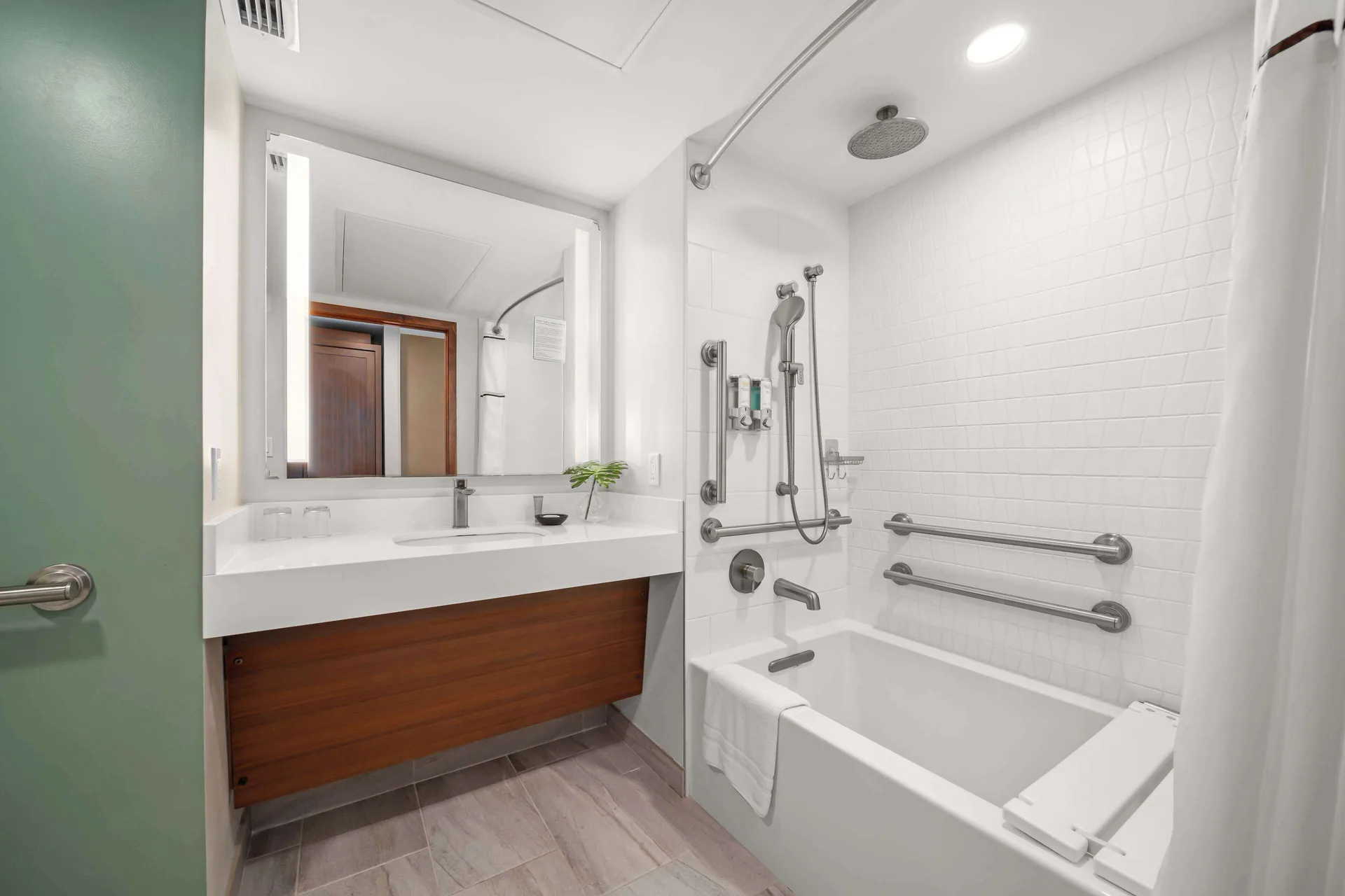 Accessible guest bathroom with tub and grab bars at Outrigger Kaanapali Beach Resort.