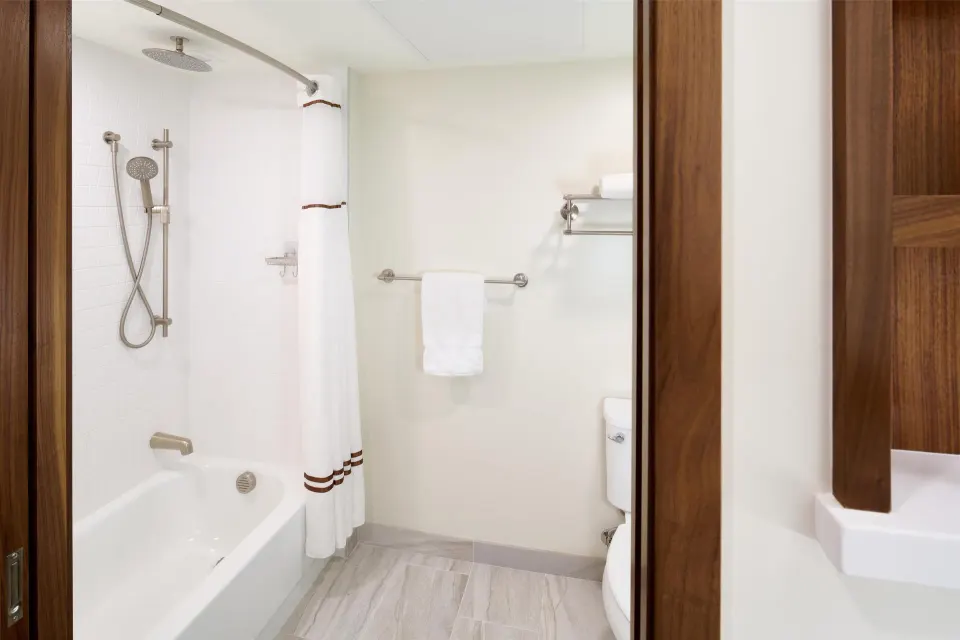 Bathtub-shower bathroom in a Premium Room Partial Ocean View at Outrigger Kaanapali Beach Resort.