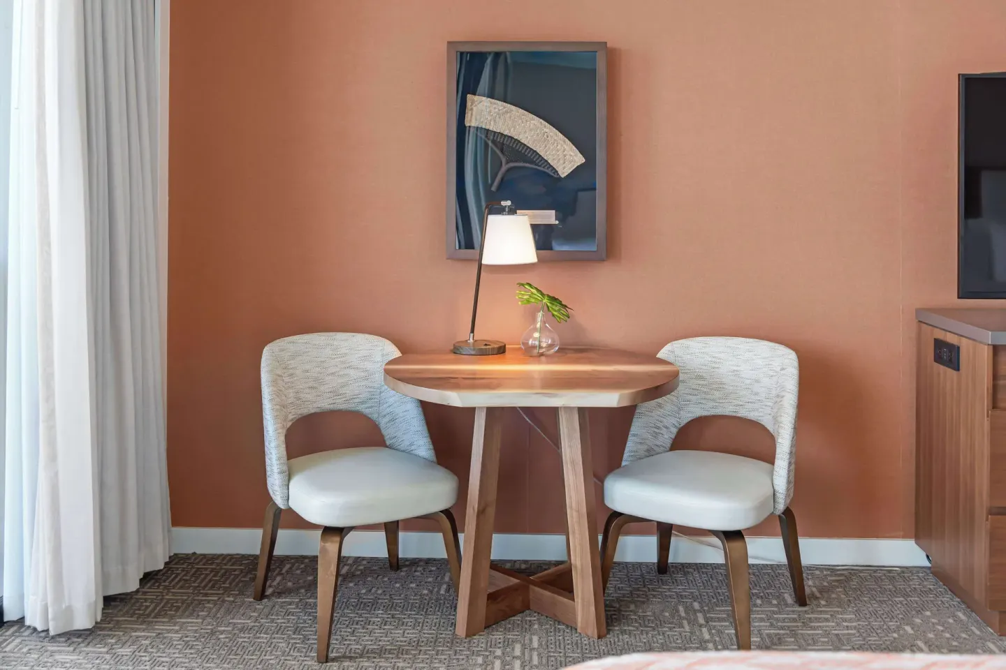 Small table and two chairs in a Premium Room Partial Ocean View at Outrigger Kaanapali Beach Resort.