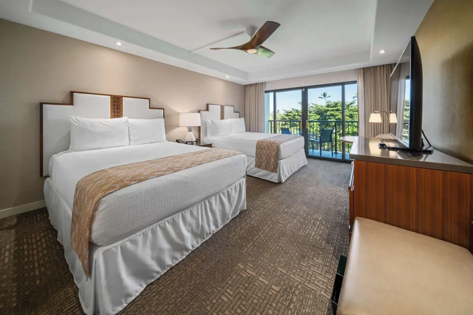 Two queen beds and balcony in a Premium Room Partial Ocean View at Outrigger Kaanapali Beach Resort.