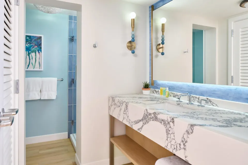 Bathroom vanity and glass shower in a guest room at Outrigger Kaanapali Beach Resort.