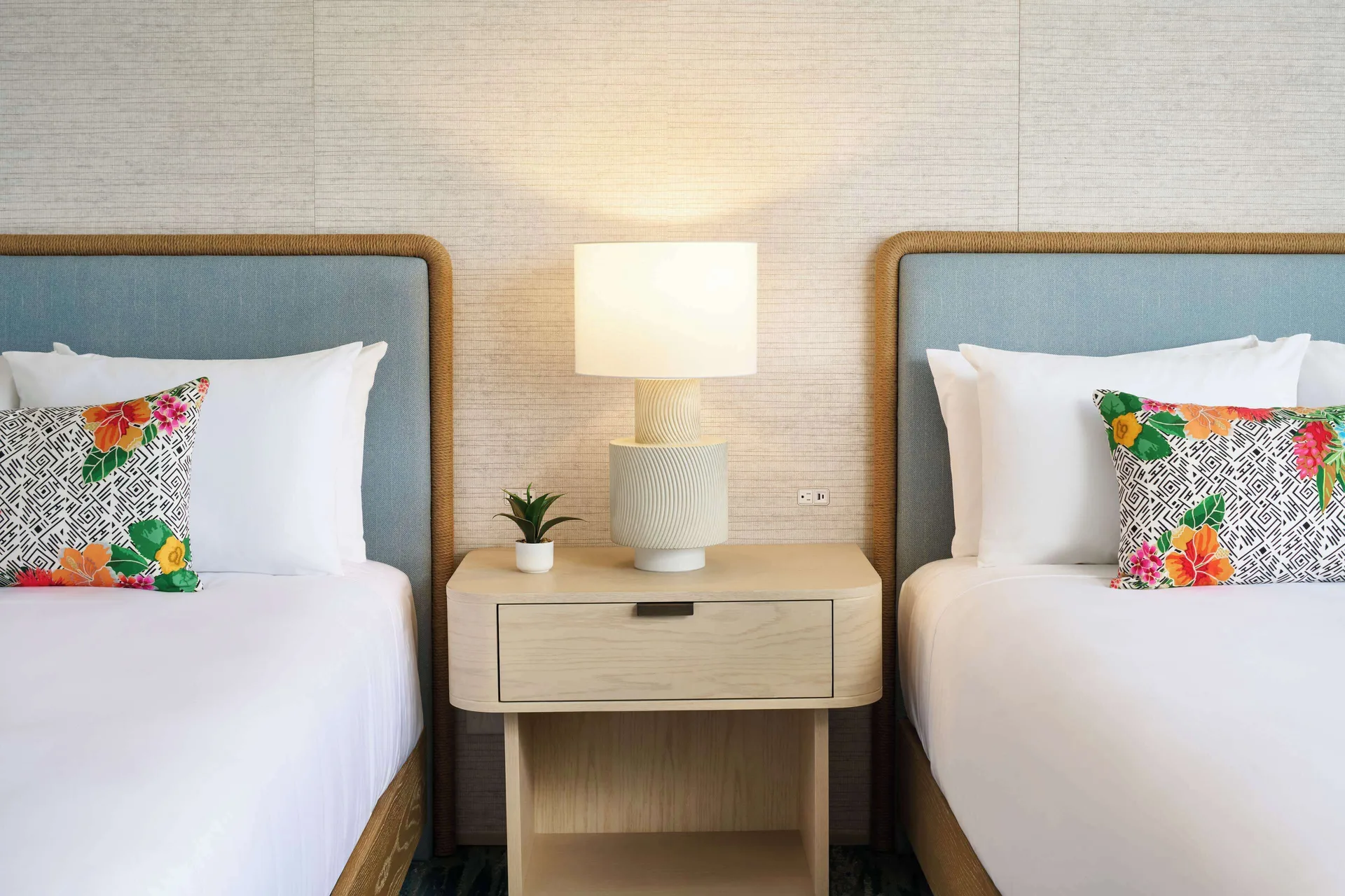 Two beds with a shared nightstand in a Signature Room at Outrigger Kaanapali Beach Resort.