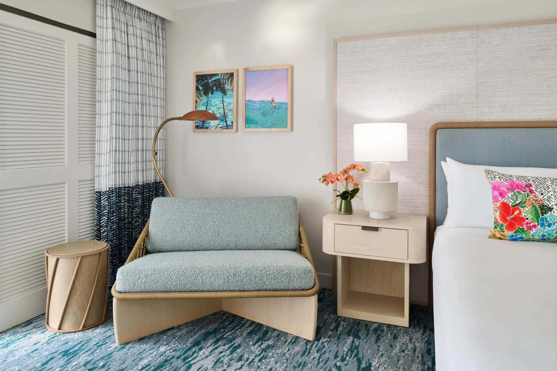 Seating area beside a king bed in a Signature Room at Outrigger Kaanapali Beach Resort.