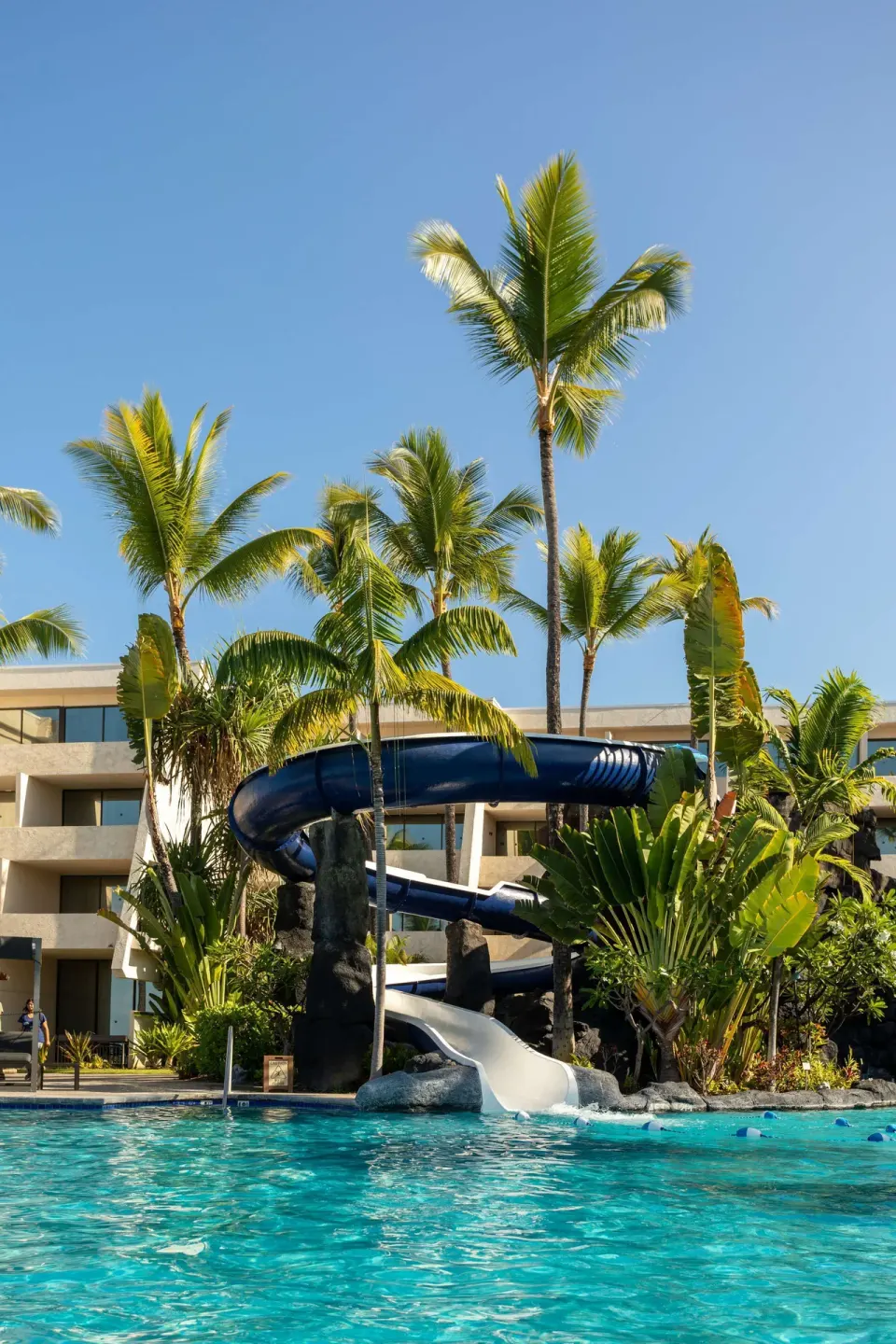 Blue spiral waterslide beside the pool at Outrigger Kona Resort and Spa.