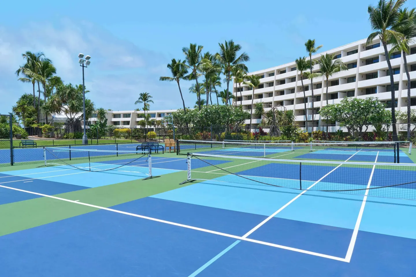 Tennis and pickleball courts near guest buildings at Outrigger Kona Resort and Spa.