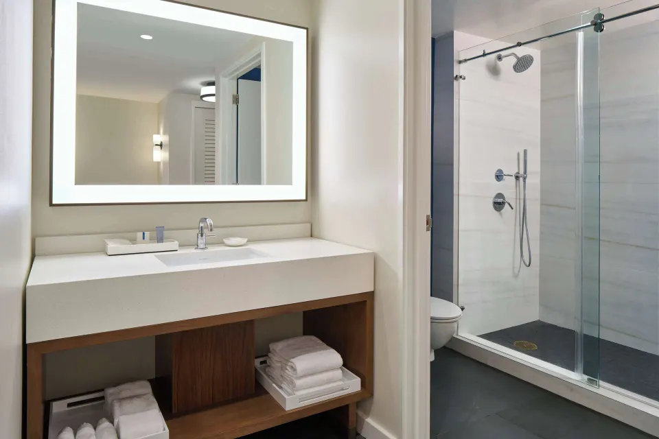Deluxe Ocean Front Suite bathroom vanity and glass shower at Outrigger Kona Resort and Spa.