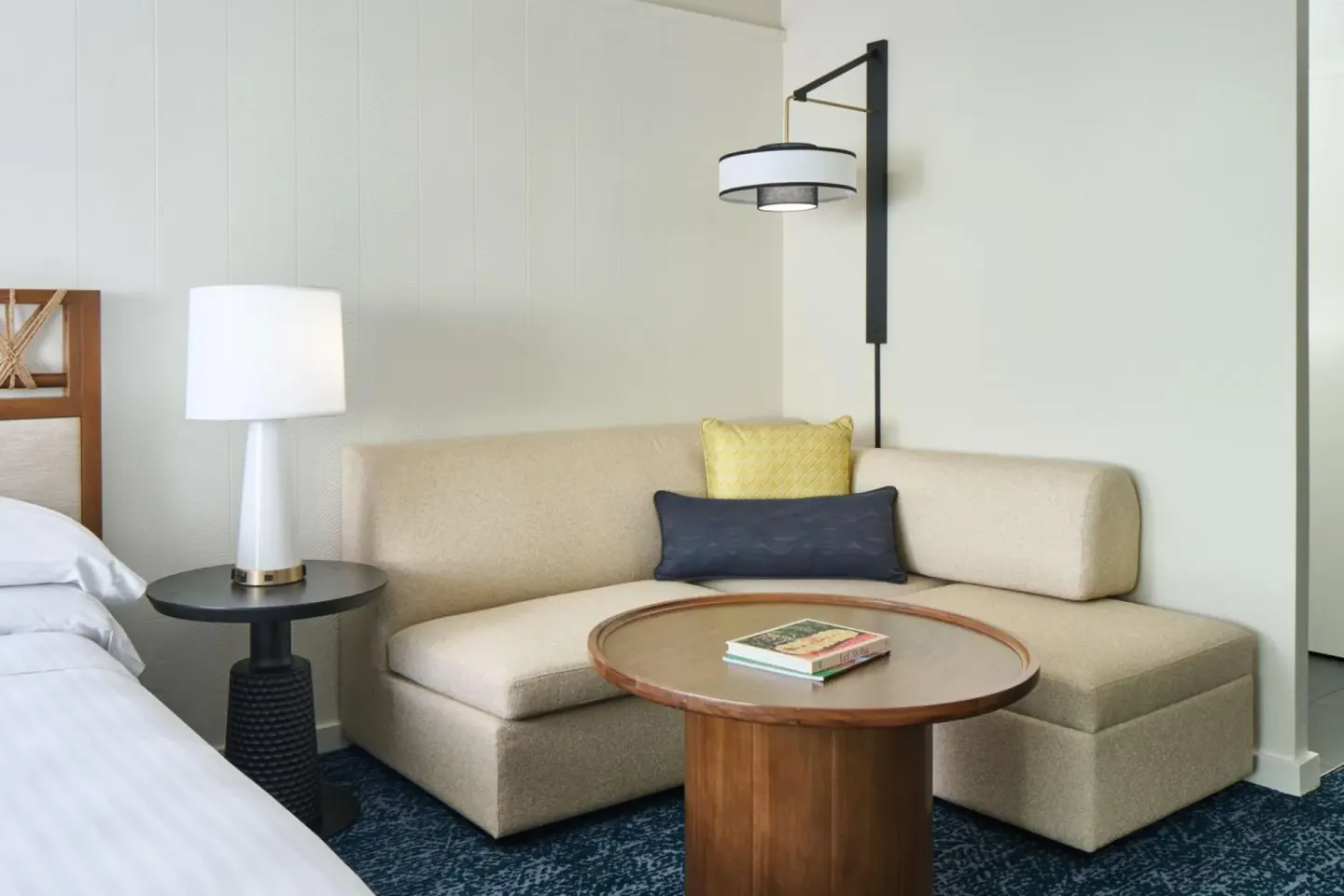 Resort View Room sofa and table beside the king bed at Outrigger Kona Resort and Spa.