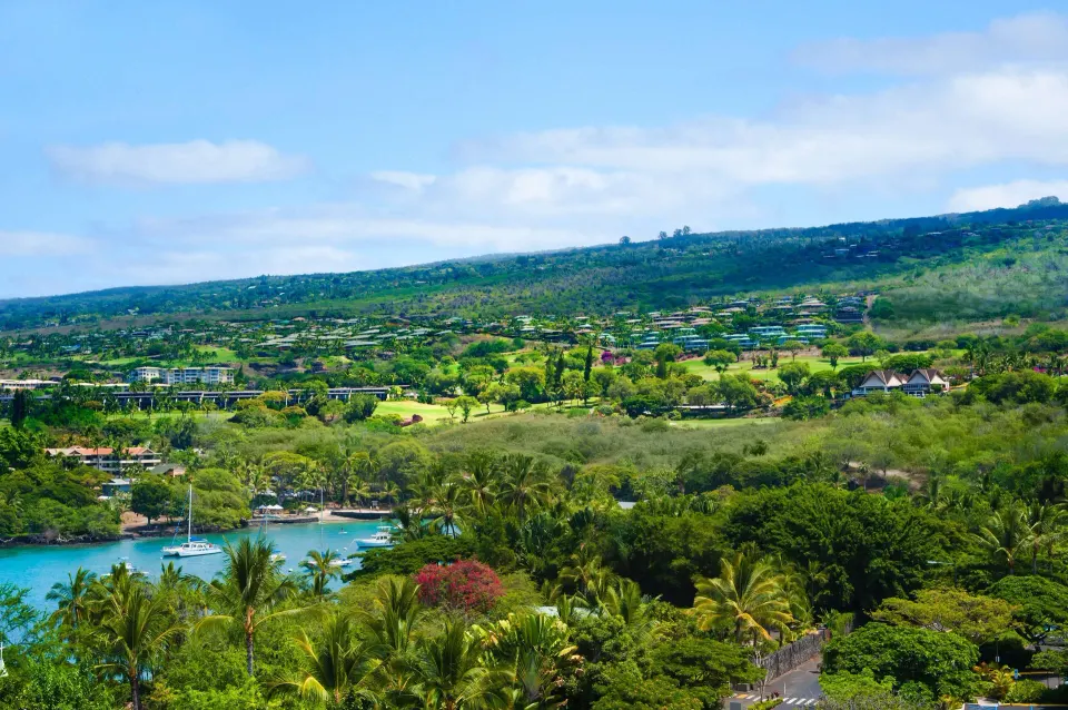 Partial ocean view room outlook over palms and Keauhou Bay at Outrigger Kona Resort and Spa.