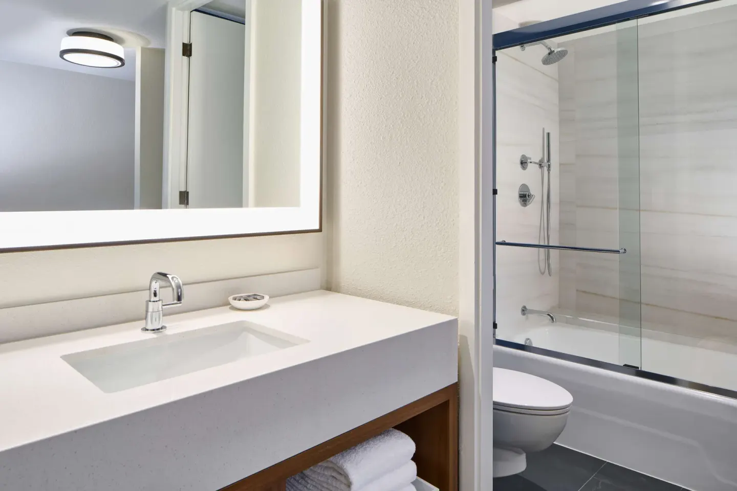 Guest room bathroom vanity and tub shower at Outrigger Kona Resort and Spa.
