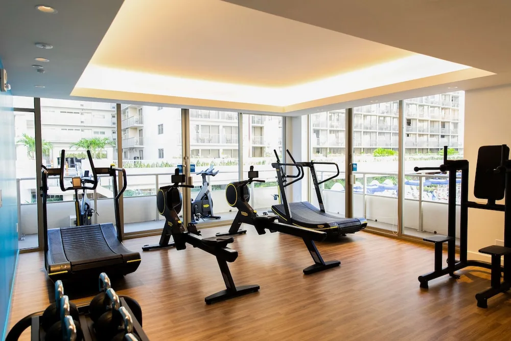 Fitness center equipment faces large windows at OUTRIGGER Reef Waikiki Beach Resort.
