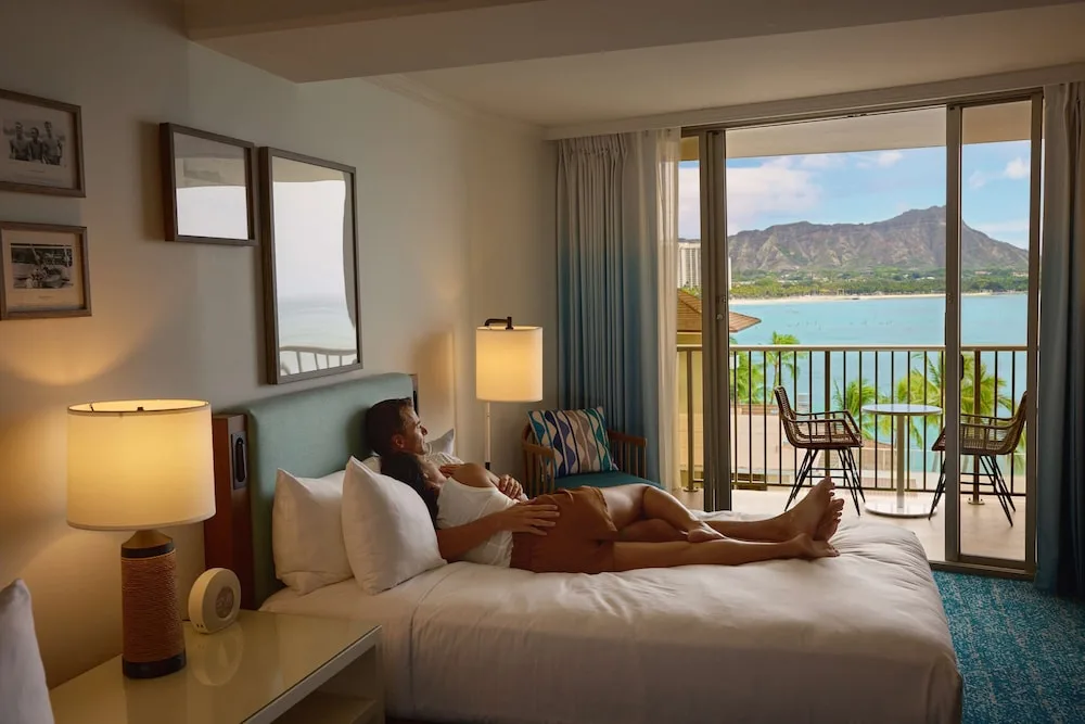Guest room with king bed and Diamond Head balcony view at OUTRIGGER Reef Waikiki Beach Resort.
