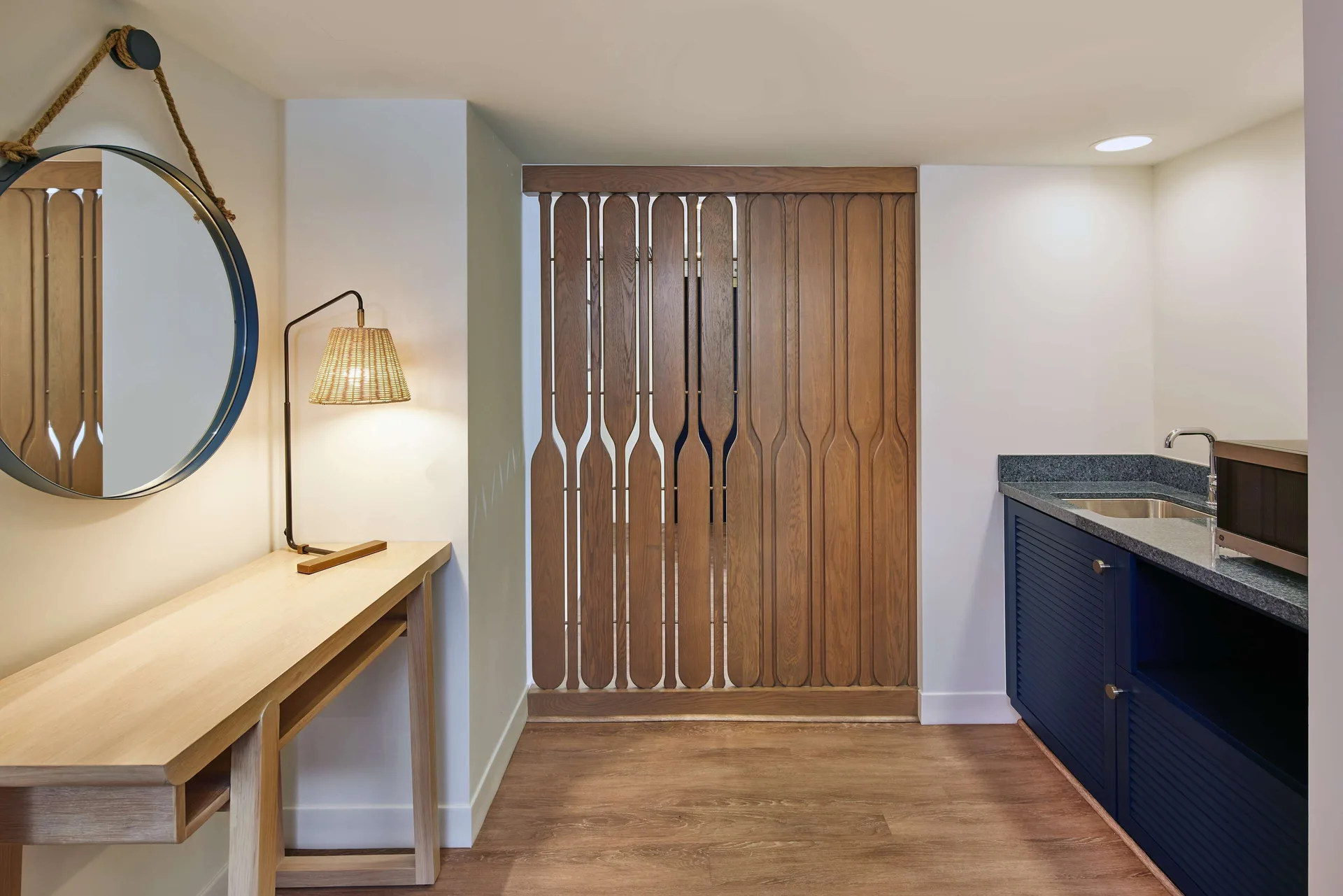 Entry wet bar with mirror, desk, sink, and wood screen at OUTRIGGER Reef Waikiki Beach Resort.