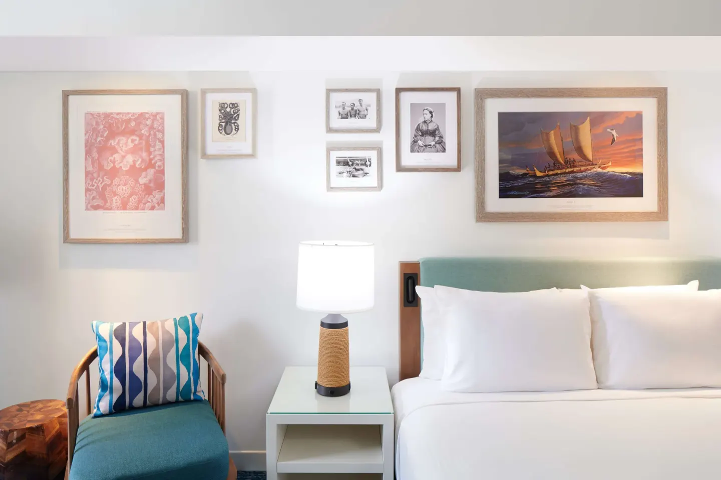 Guest room king bed and bedside seating at OUTRIGGER Reef Waikiki Beach Resort.