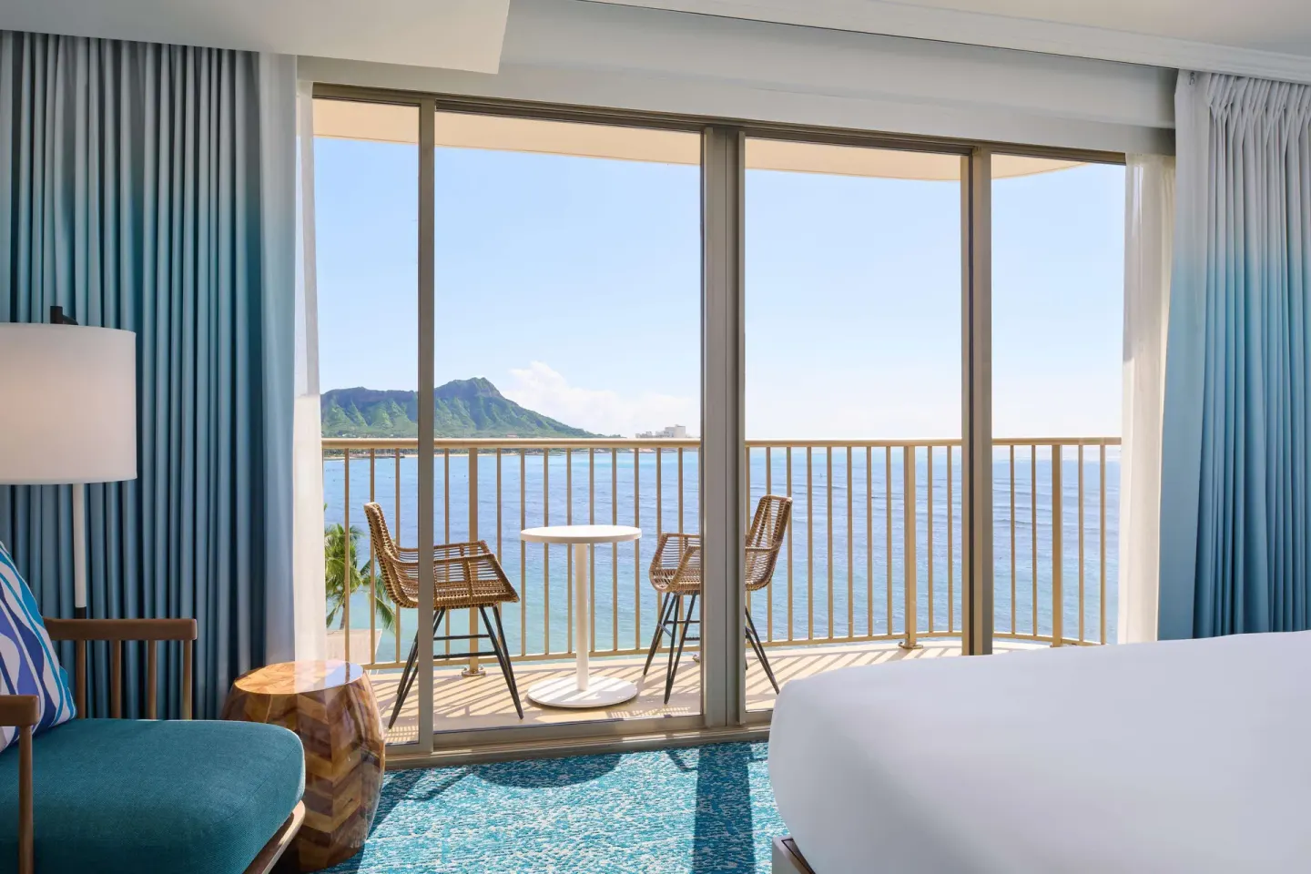 King-bed guest room balcony with Diamond Head and ocean view at OUTRIGGER Reef Waikiki Beach Resort.