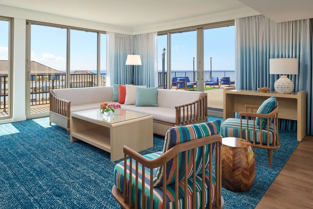 Oceanfront living room with balcony seating at OUTRIGGER Reef Waikiki Beach Resort.