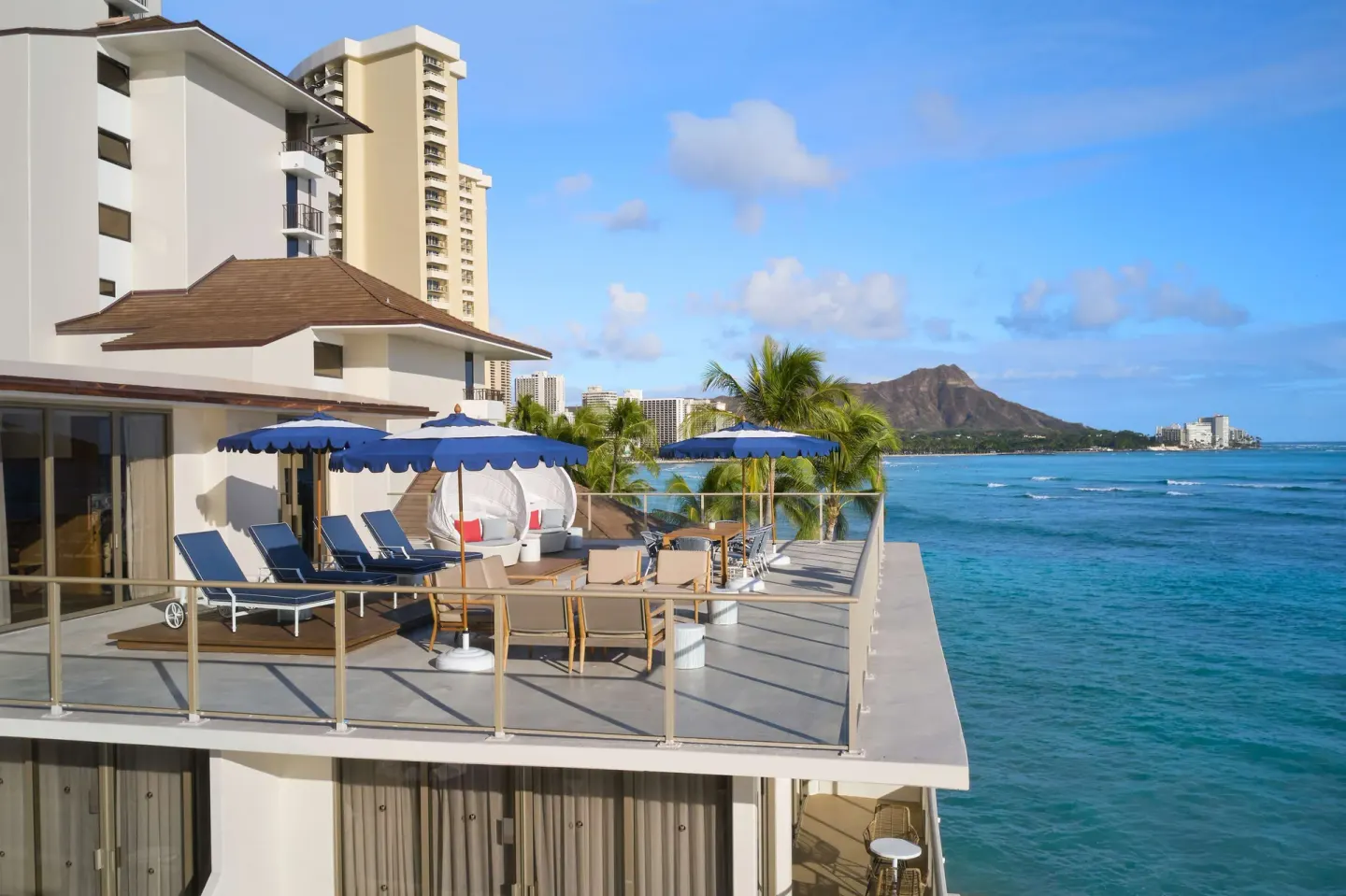 Oceanfront sundeck with loungers and Diamond Head view at OUTRIGGER Reef Waikiki Beach Resort.