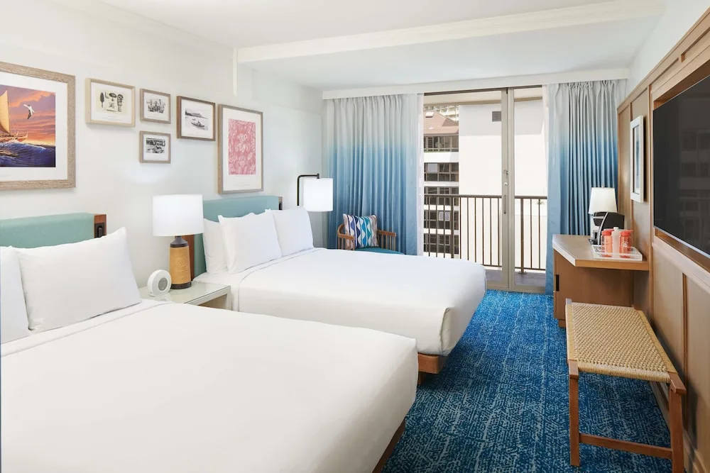 Two-bed guest room with balcony at OUTRIGGER Reef Waikiki Beach Resort.
