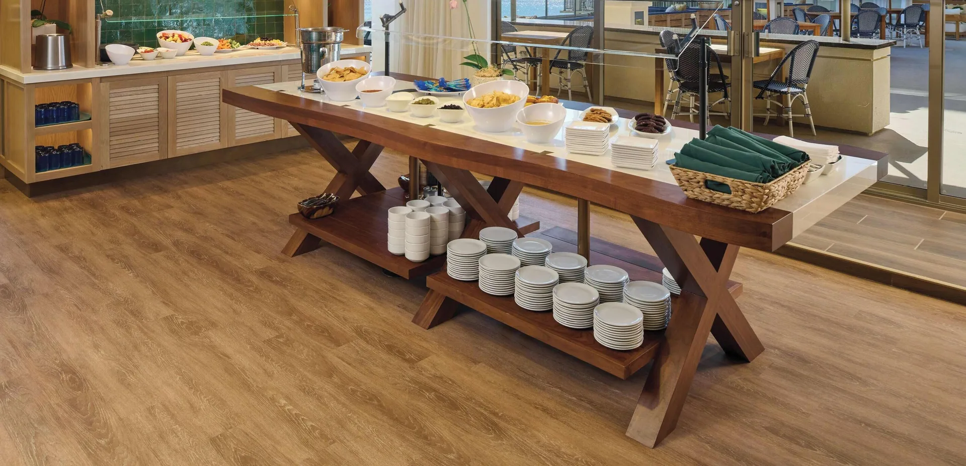 Buffet table with plates, bowls, and food at OUTRIGGER Reef Waikiki Beach Resort.