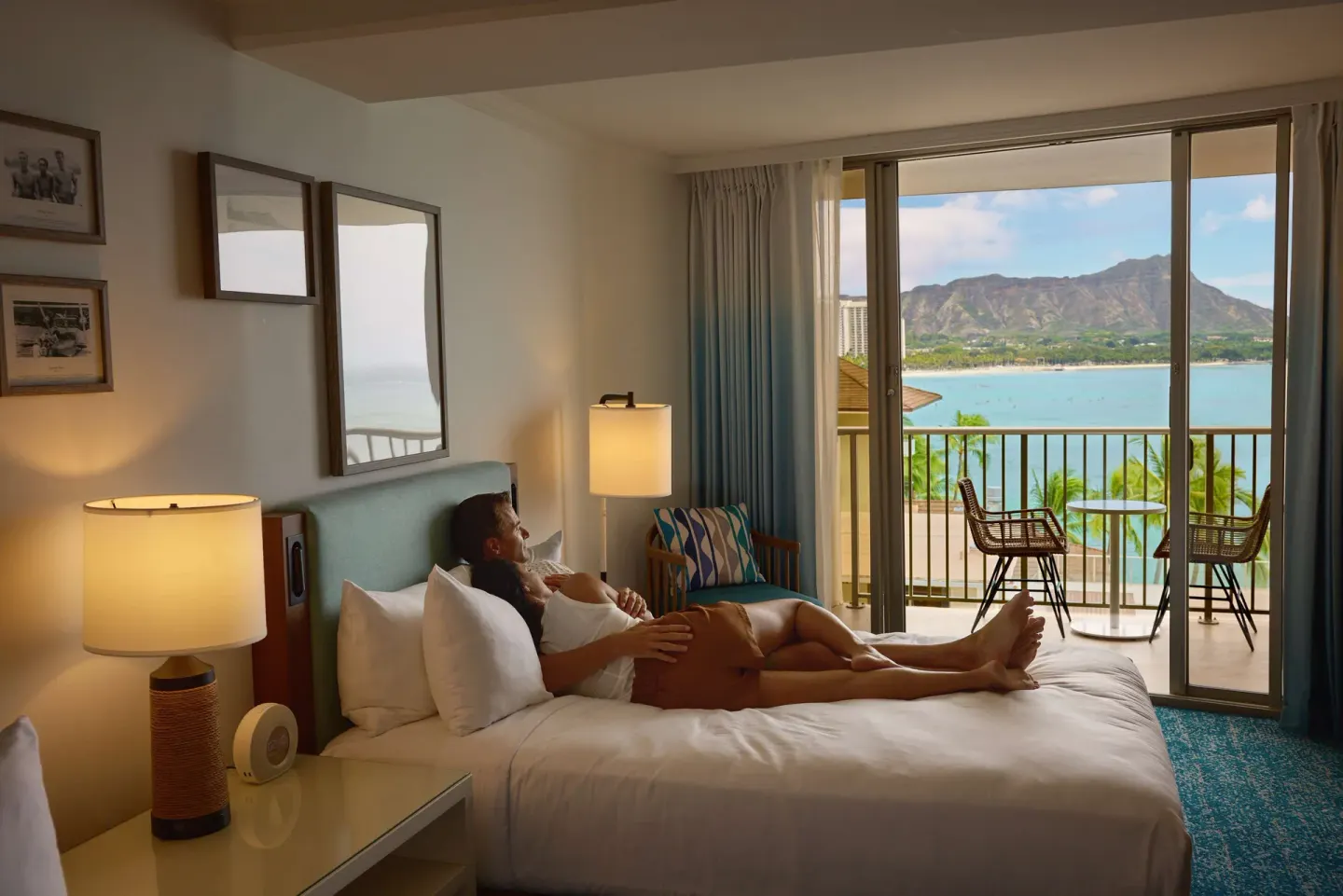 Club Suite king bed and balcony with Diamond Head view at OUTRIGGER Reef Waikiki Beach Resort.